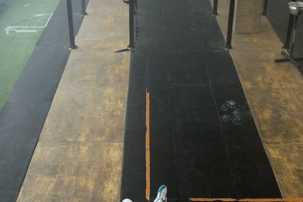A set of sports equipment lying on a clean gym floor.