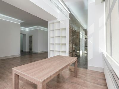 Bright and airy training room with wooden floors.